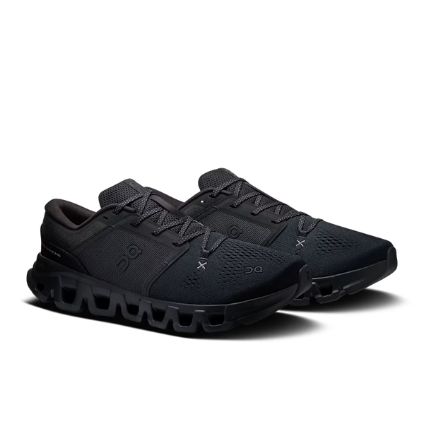 A pair of black On Cloud X 5 sneakers shown from a three-quarters angle against a clean white background.