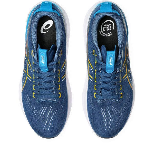 Blue running shoes with yellow accents on a white background