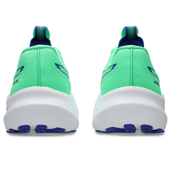 Green and blue running shoes with white soles on a white background