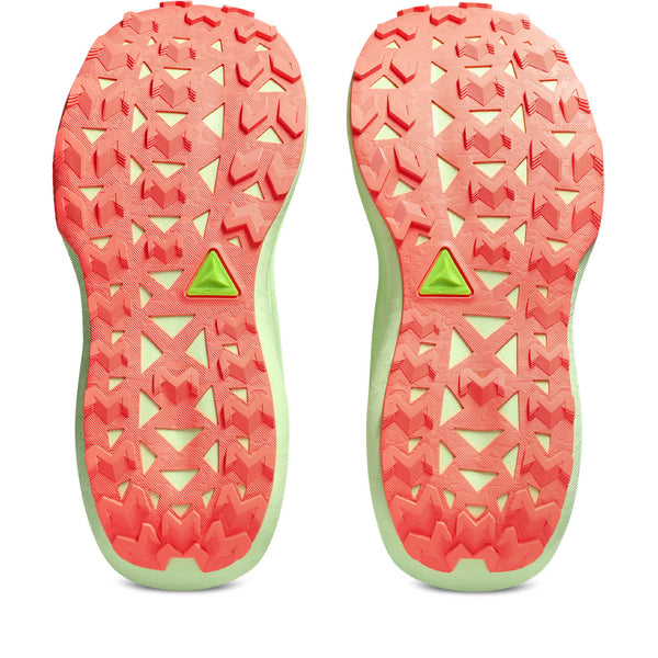Close-up of pink and green shoe soles with a geometric pattern on a white background