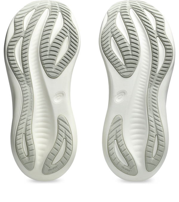 Close-up of white shoe soles with a brand logo on a white background