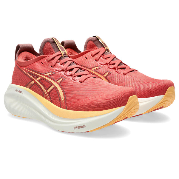 Red running shoes with gold accents on a white background