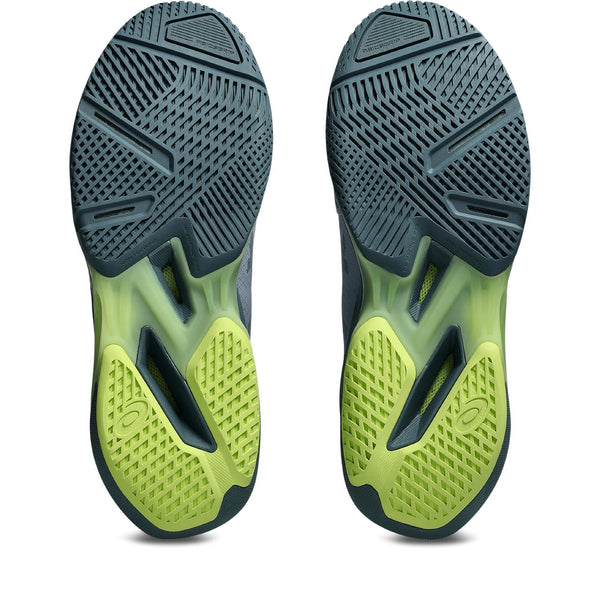 Close-up of green and black athletic shoe soles on a white background