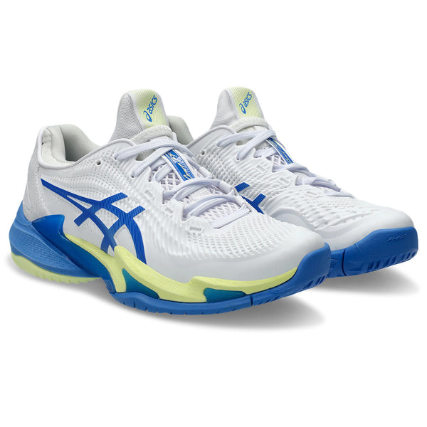 A pair of tennis shoes with blue and green accents sitting at an angle that shows off the entire shoe on a white background.