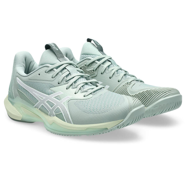 Pair of light blue running shoes on a white background