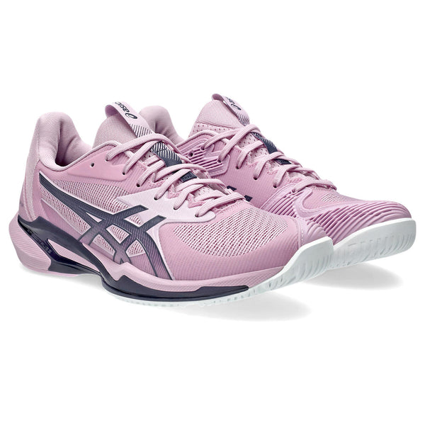 Pink athletic shoes with white soles on a white background