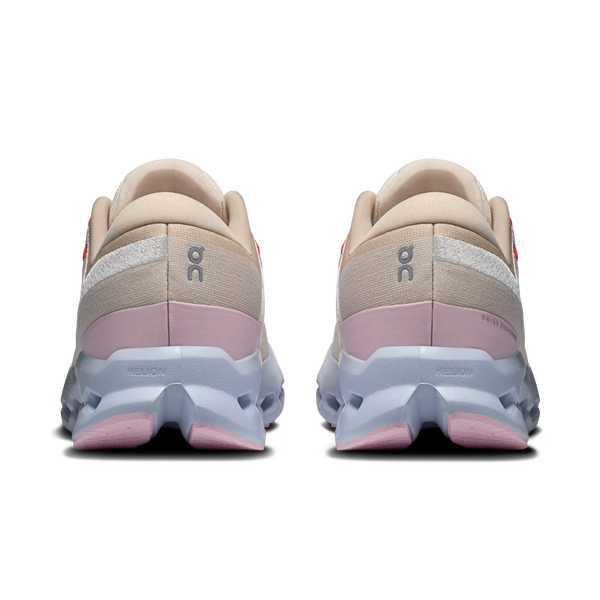 Pair of beige and pink running shoes with a visible brand logo on a white background