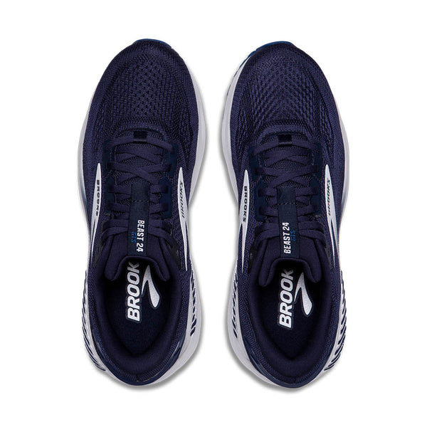 A pair of men's running shoes from Brooks that have a navy upper and white midsole.