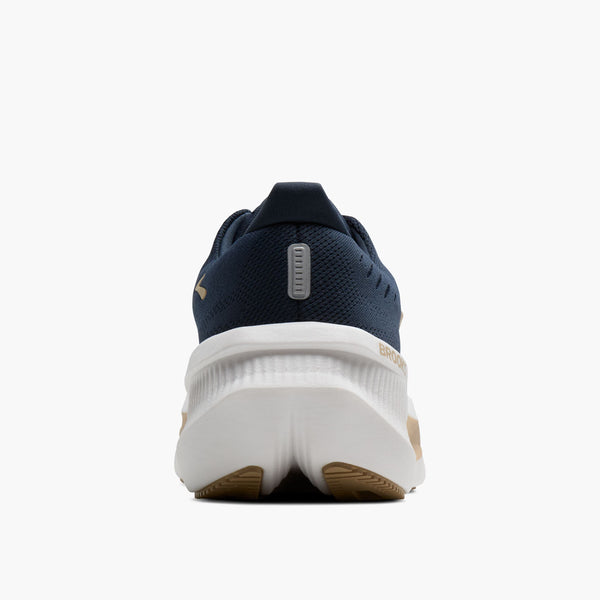 Navy running shoe with white sole on a white background