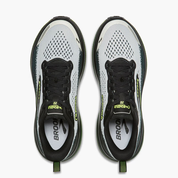 A pair of Brooks Cascadia 10 trail running shoes shown from a top-down view against a clean white background. The shoes feature a white and gray mesh upper with black laces, black midsoles, and bright neon yellow-green accents on the tongue, heel, and pull tabs.