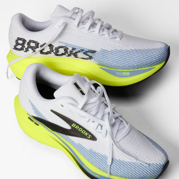 Brooks Ghost Run 14 running shoe in white, featuring a light blue gradient mesh upper, a black side logo stripe with yellow 'BROOKS' text, and a bright yellow-green Ghost Air midsole.