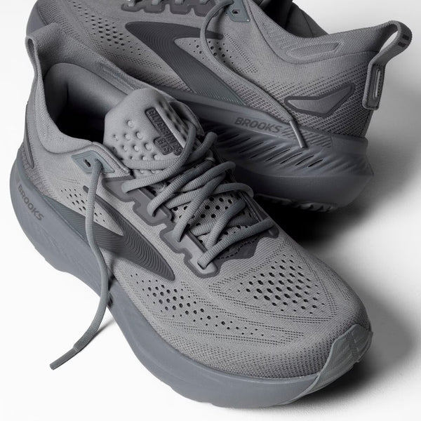 Gray running shoes with 'Brooks' branding on a white background