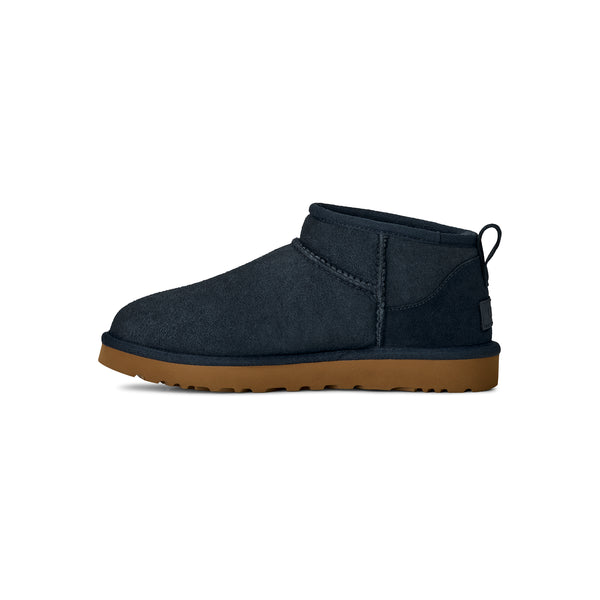 Navy ugg slipper with a tan midsole
