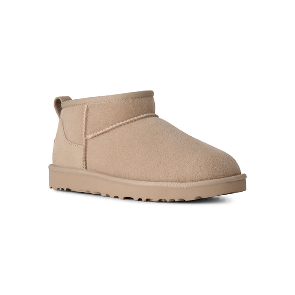 Ankle length beige slipper boot on a white background