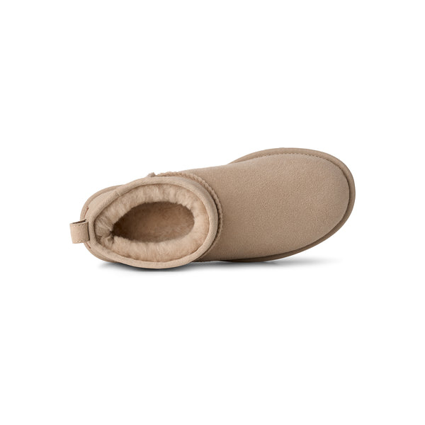 Ankle length beige slipper boot on a white background