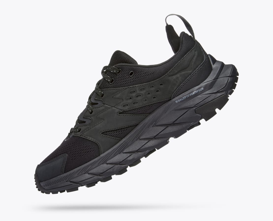 Medial angled view of the Men's Anacapa Breeze Low trail shoe by HOKA in the color All Black
