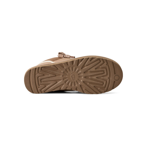 Light tan sneakers on a white background