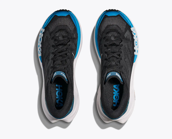 Black and blue running shoes with white soles on a white background