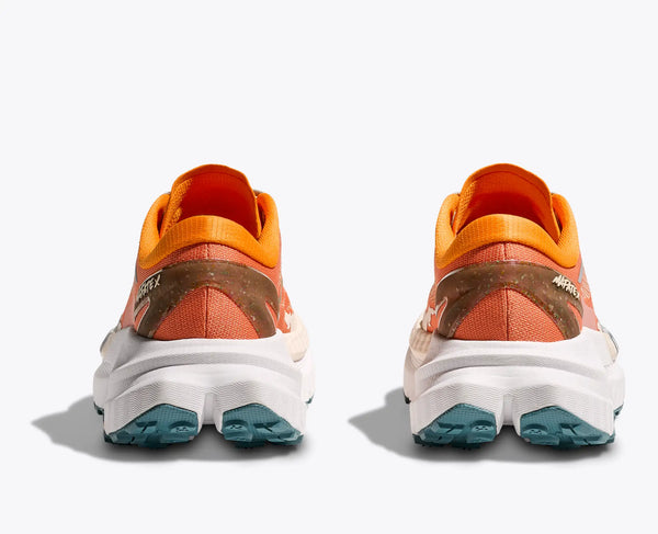 Orange and brown running shoes with blue soles on a white background