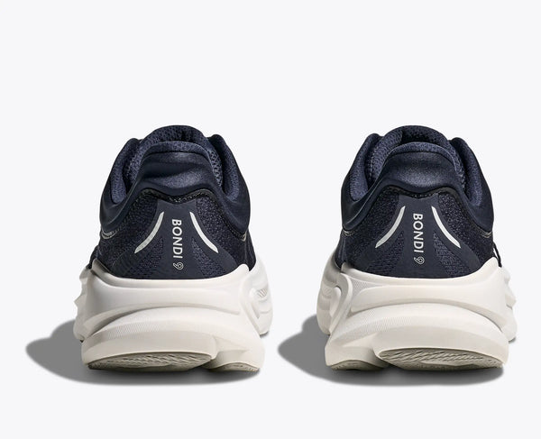 Navy running shoes with white soles on a light gray background