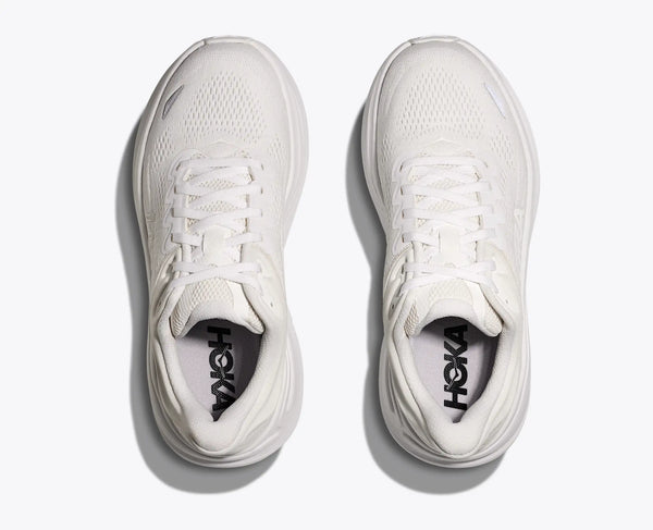 White running shoes with 'Hoka' branding on a light gray background