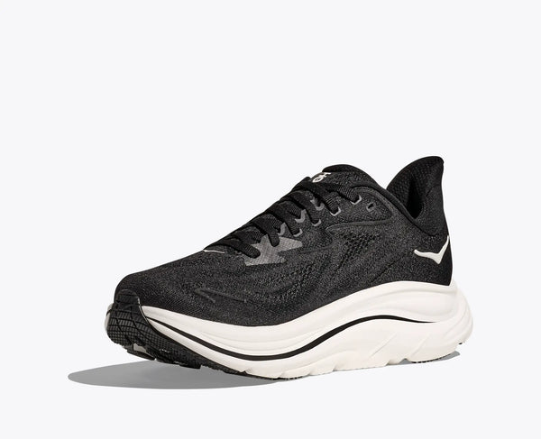 The medial side of this running shoe is almos all black exept for a white Hoka logo.