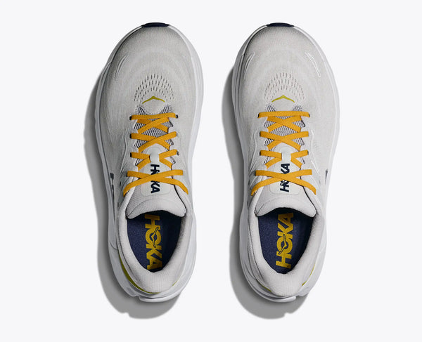 White running shoes with yellow laces that look like a boot and visible branding on a white background.