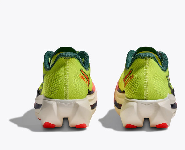 Pair of bright green carbon plated running shoes with red accents on a white background