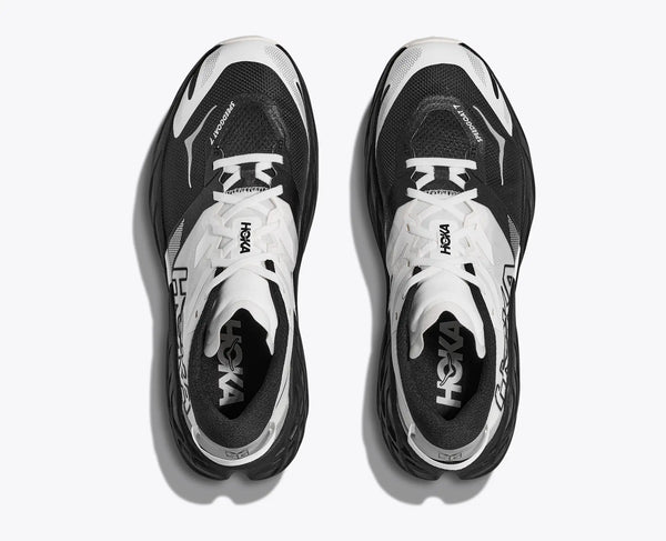 Black and white running shoes with 'Hoka' branding on a white background