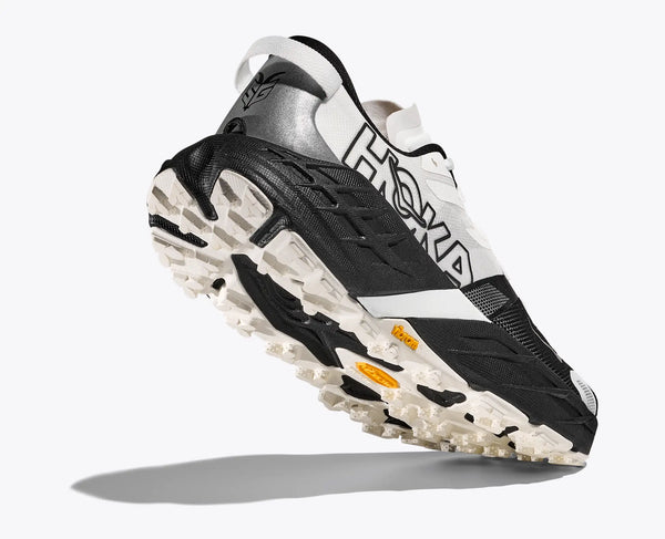 Black and white running shoe with brand logo on a white background