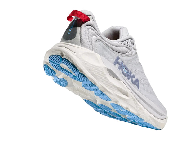 White running shoe with blue sole and red tag on a white background