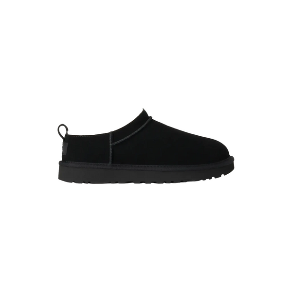 Black slip-on shoe on a white background