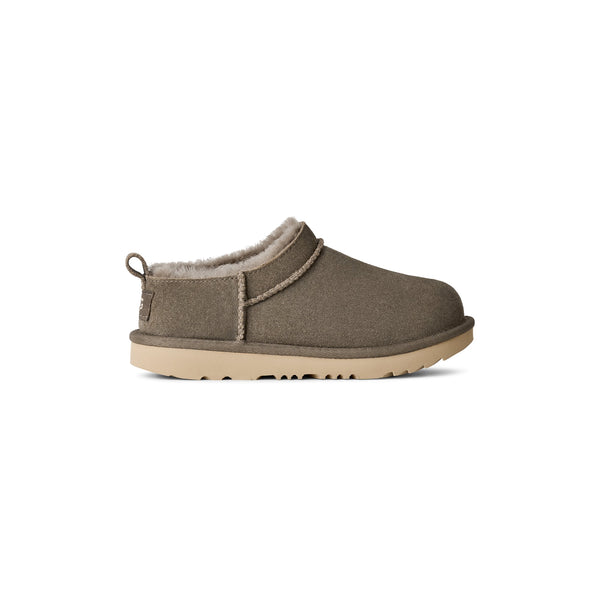 Green kids slipper on a white background