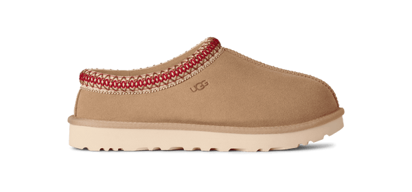 Tan slipper with red trim on a green background