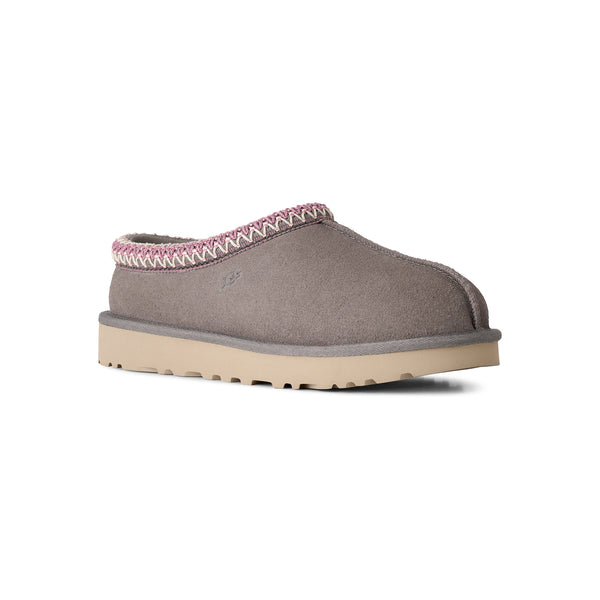 Grey, pink, and tan slipper on a white background