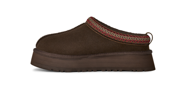 Brown slip-on shoe with a platform sole on a white background
