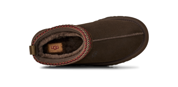 Brown slip-on shoe with a platform sole on a white background