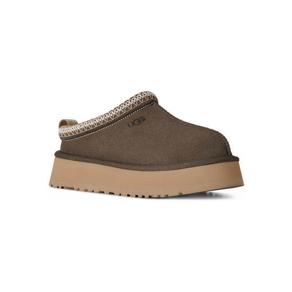 Deep green ugg slipper on a white background