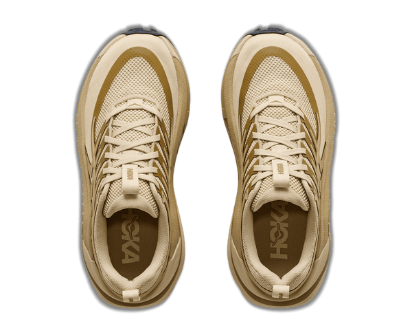 Tan trail running shoe on a white background