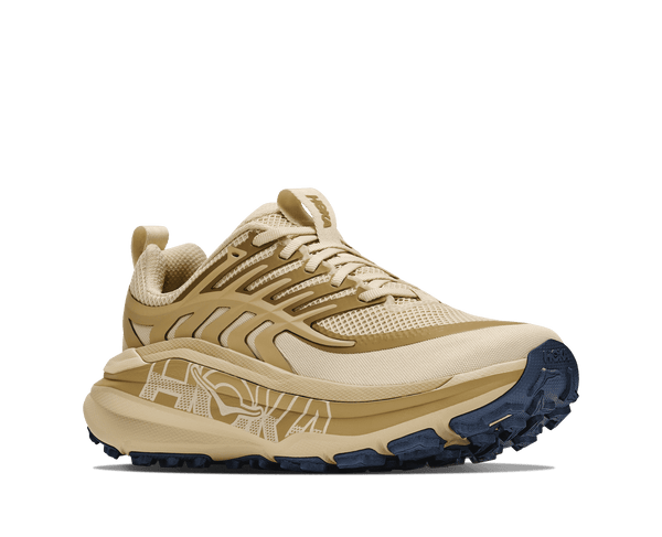 Tan trail running shoe on a white background