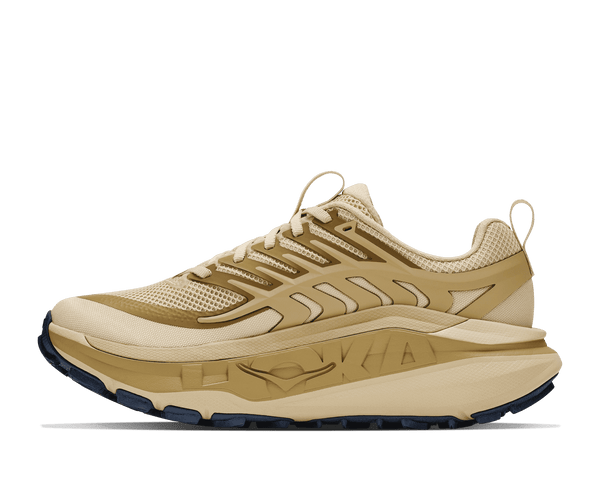 Tan trail running shoe on a white background