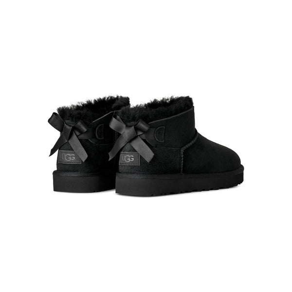 Black ankle length slipper boot with bow on the back
