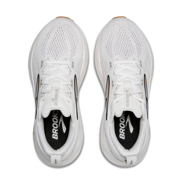 White running shoes with 'Brooks' branding on a white background