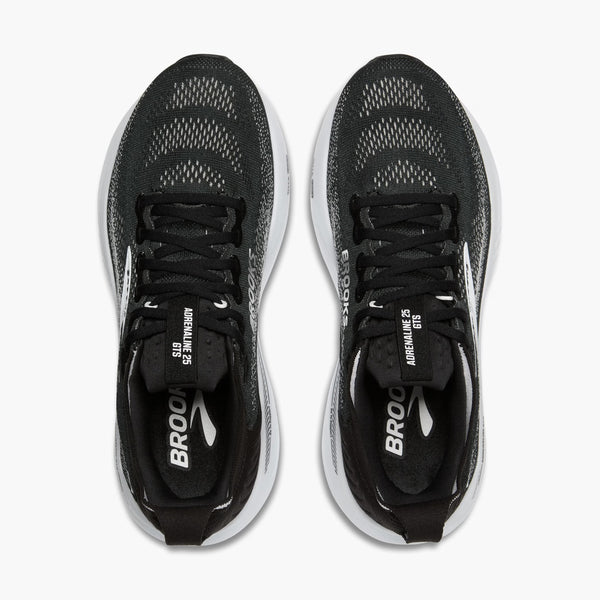 A pair of black running shoes with white soles on a white background