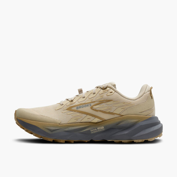 Beige running shoe with gray sole on a white background