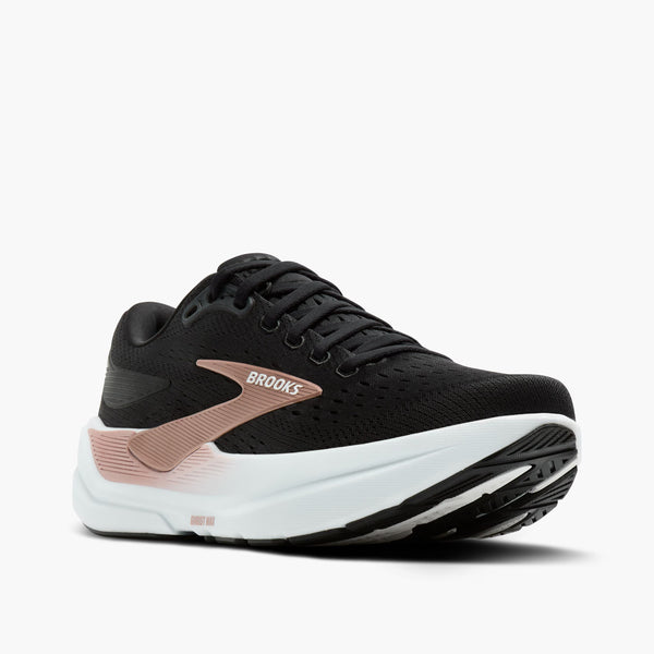 Black and white running shoe with pink accents on a white background
