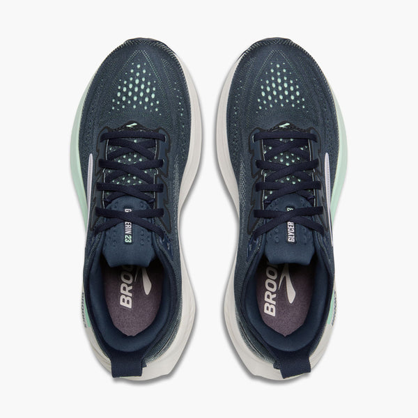 Pair of navy running shoes with white soles on a white background