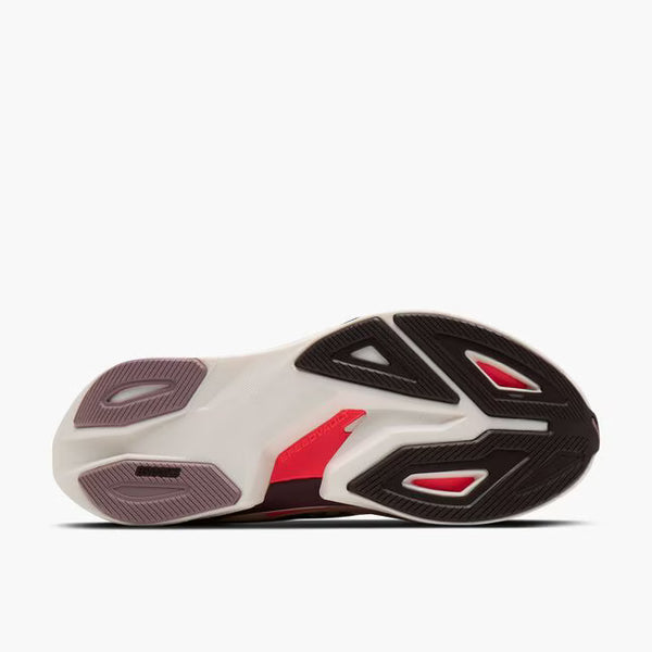 Side view of a white sneaker with black and red accents on a white background