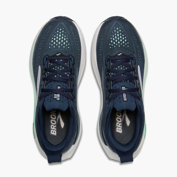 Navy running shoe with white sole on a white background