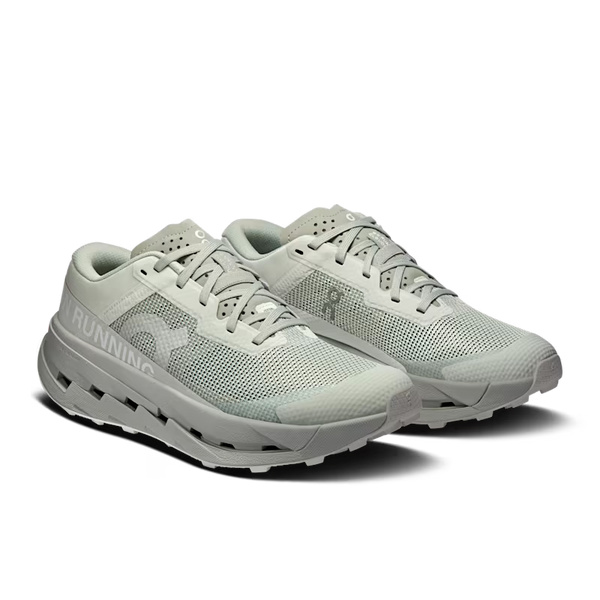 White athletic shoes with visible brand logo on a white background